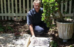 Garry Clark, alongside his ancestors plaque, which is at the rear of the church, close to the picket fence